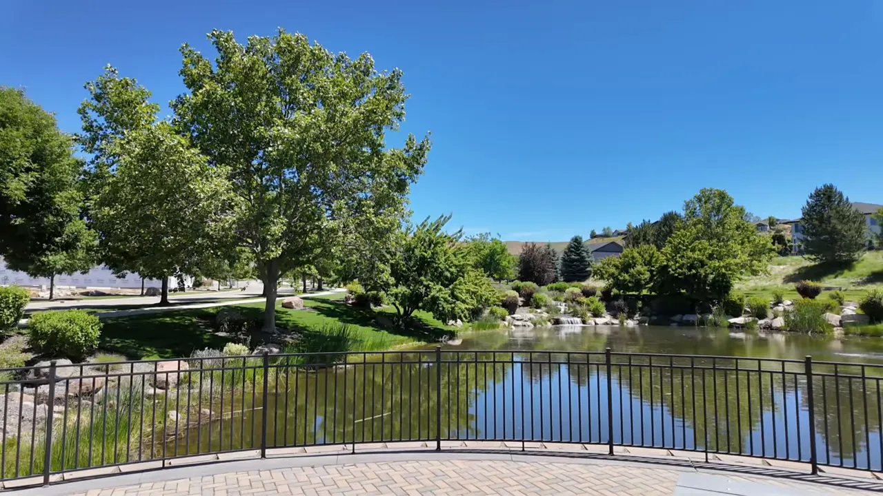 Stocked community fishing pond with benches and trees