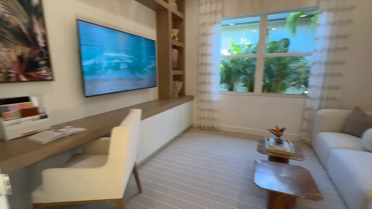 Valencia Sky Stellar great room featuring open seating area, media wall, and large window