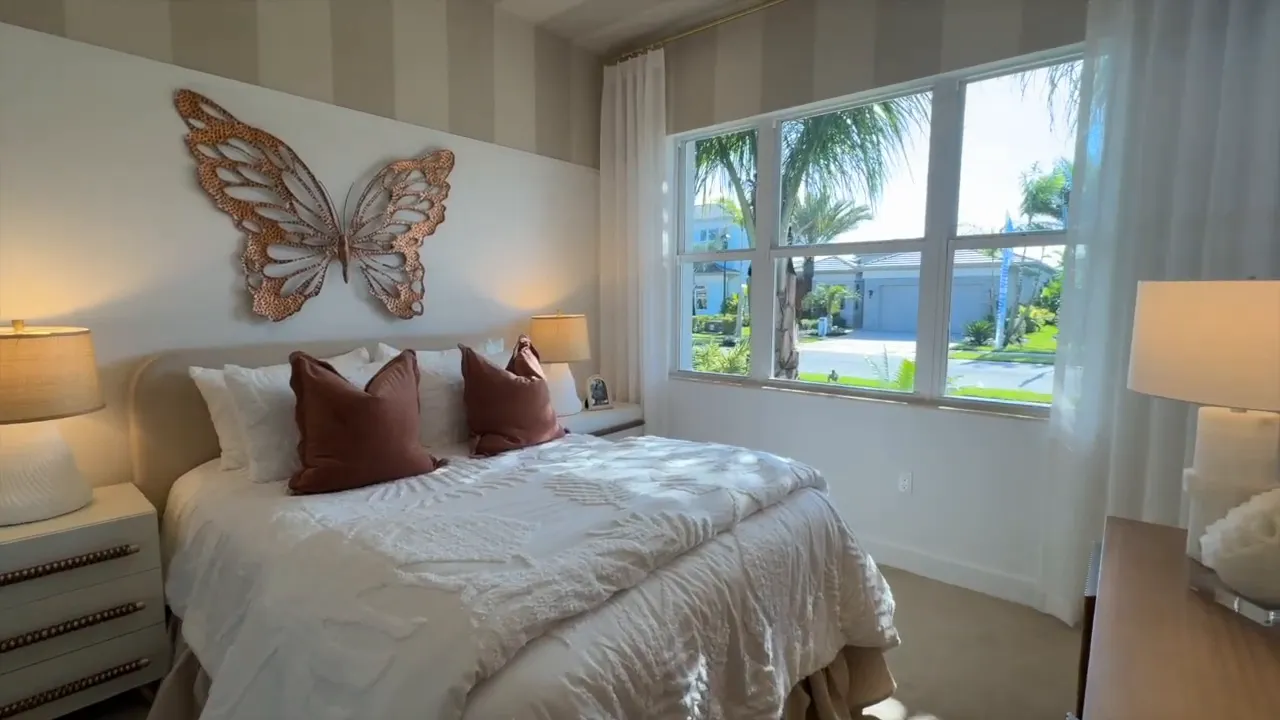 Wide view of Stellar front guest bedroom with bed and bay windows at Valencia Sky