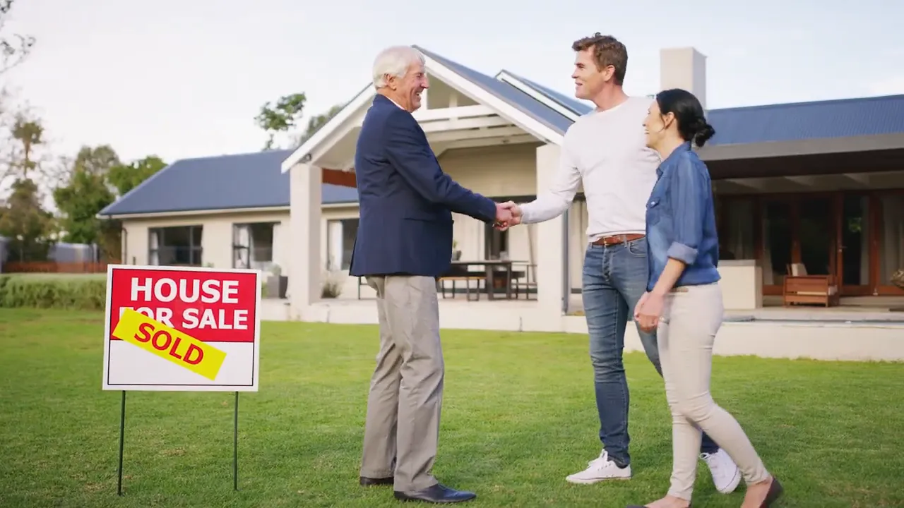 Real estate agent handshake outside a modern house with house-for-sale sold sign in yard
