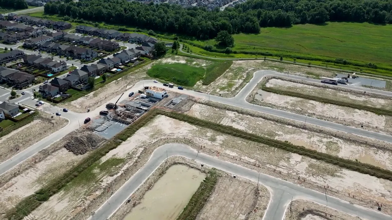 Aerial view of a housing development showing roads and available lots in an inventory community