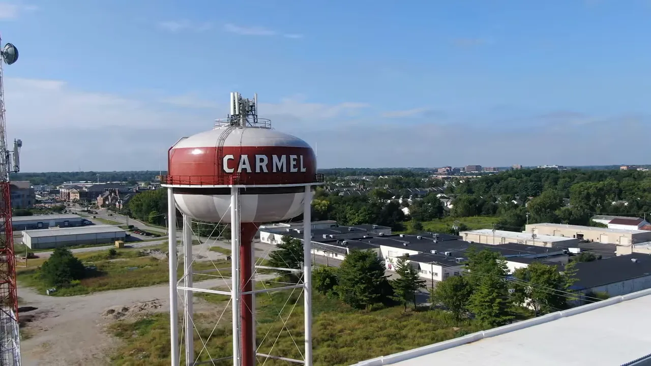 Aerial view of the Carmel water tower with residential and commercial areas in the background.