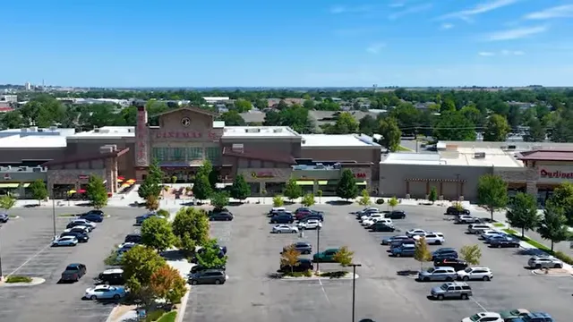 Aerial view of a large shopping center and parking lot