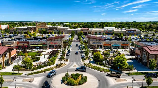 Aerial view of a shopping district with a landscaped roundabout