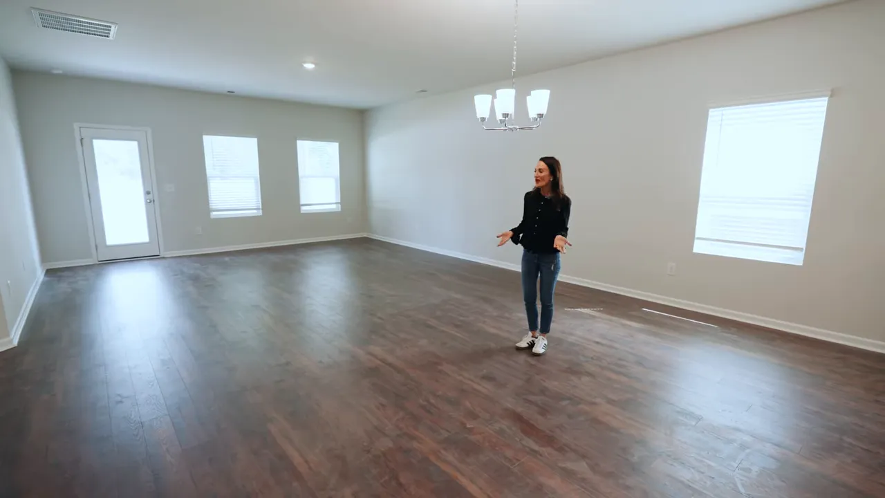 Living room with natural light and hardwood-look flooring in a Conway SC new construction home