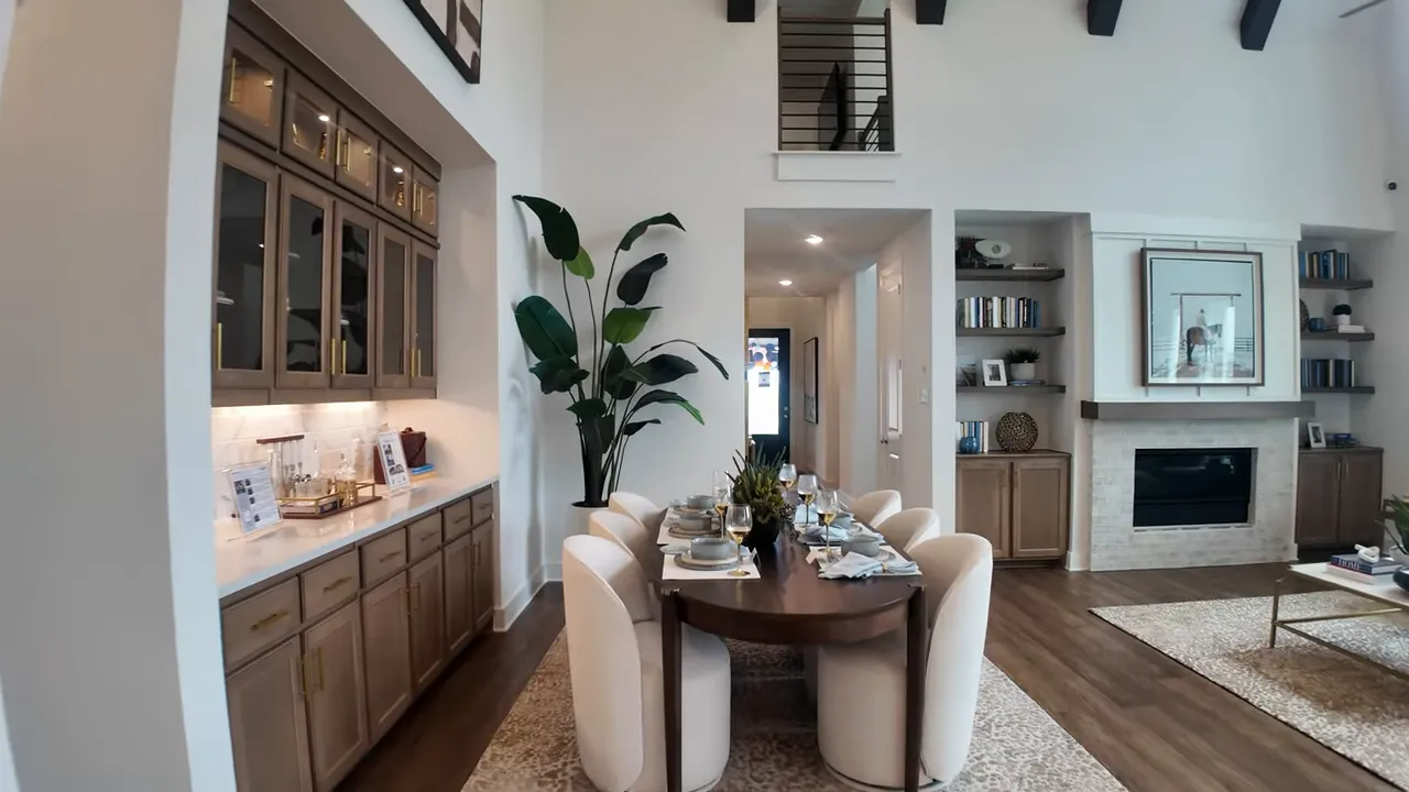 Dining area with built in glass upper cabinets, counter space and table set for four