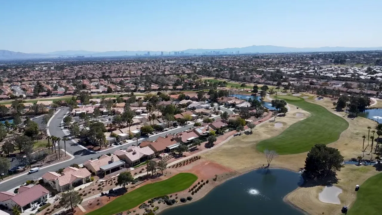 Aerial view of a golf course water feature and surrounding homes