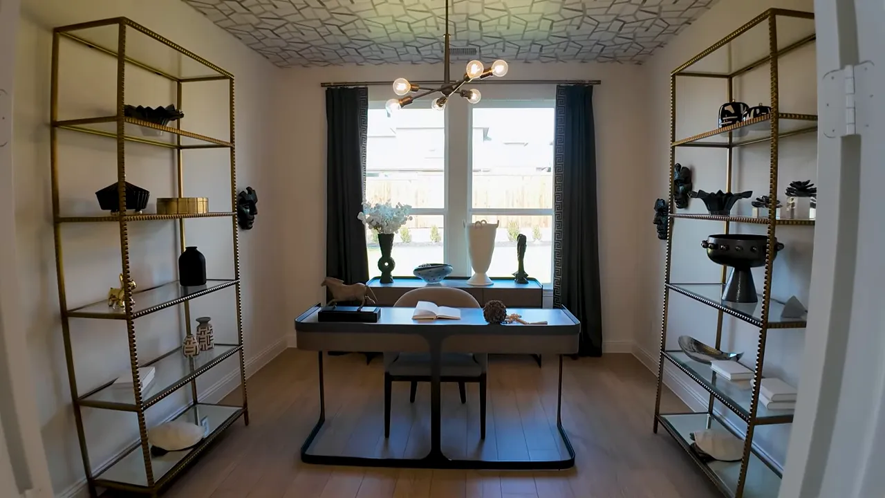 Home office centered in the floor plan with double doors and view back through the house