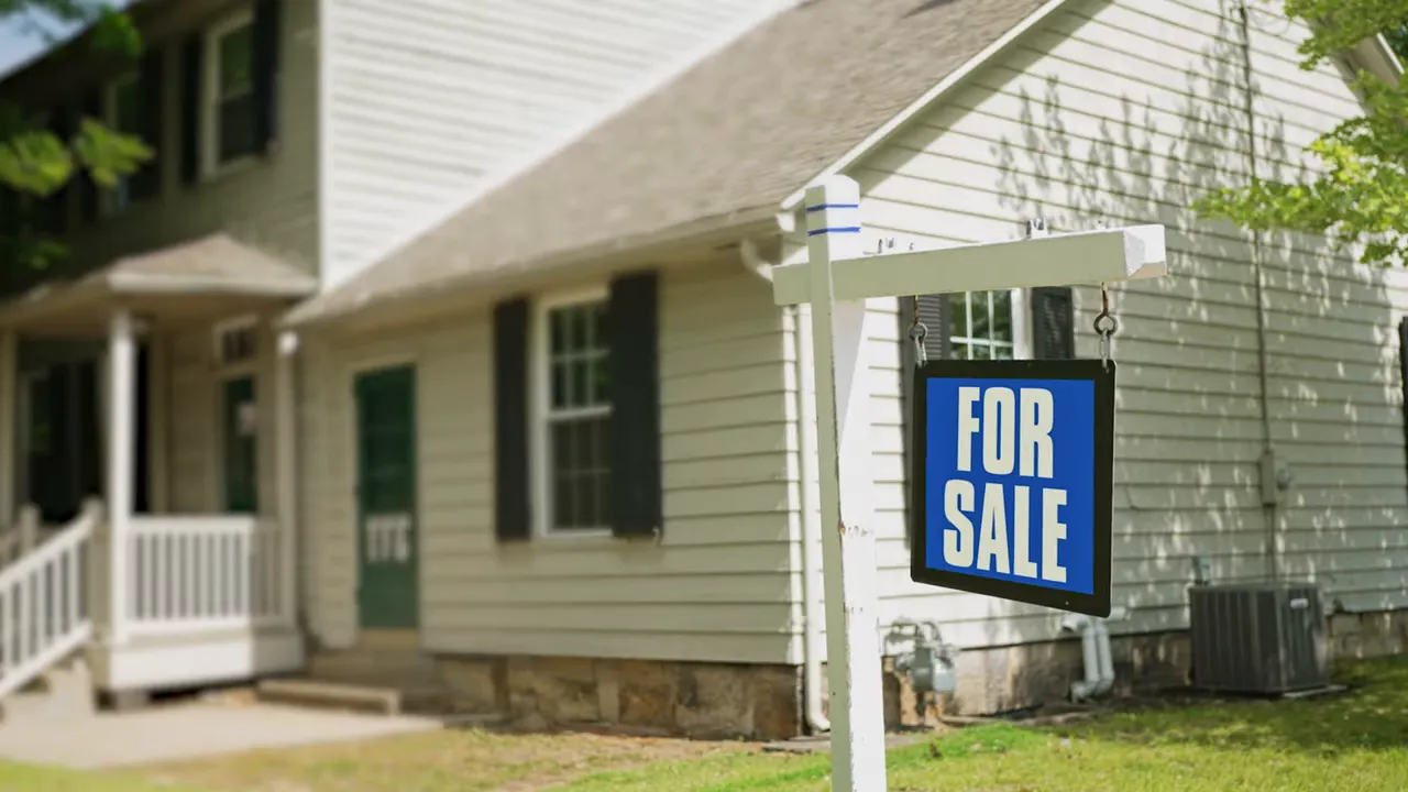 For sale sign in front of a suburban house