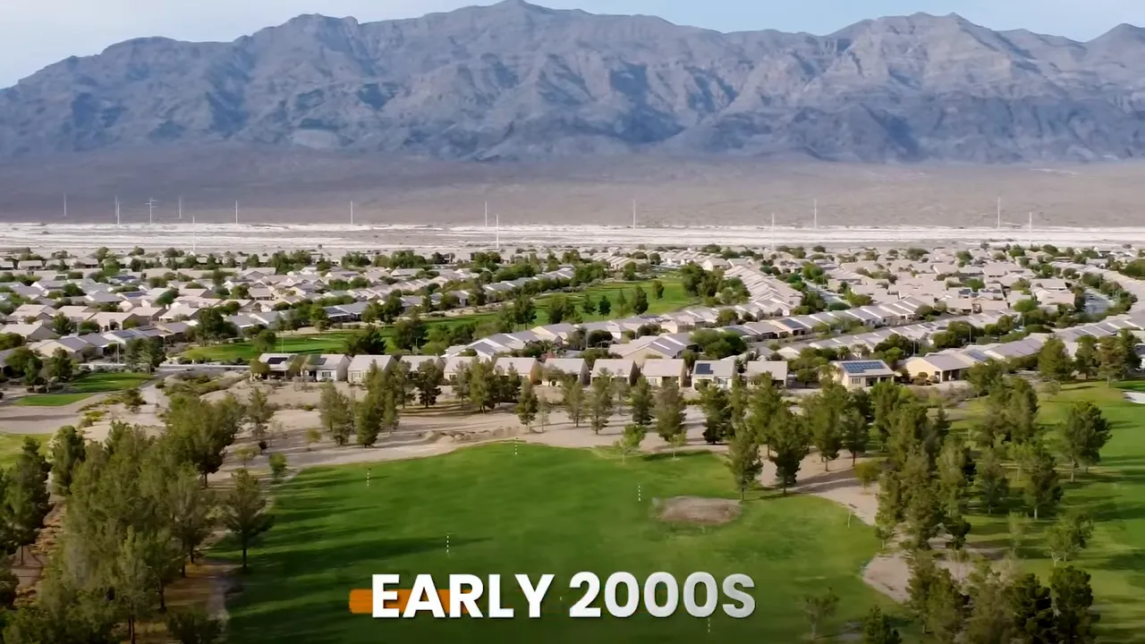 Aerial view of golf course clubhouse and surrounding neighborhood with early 2000s text