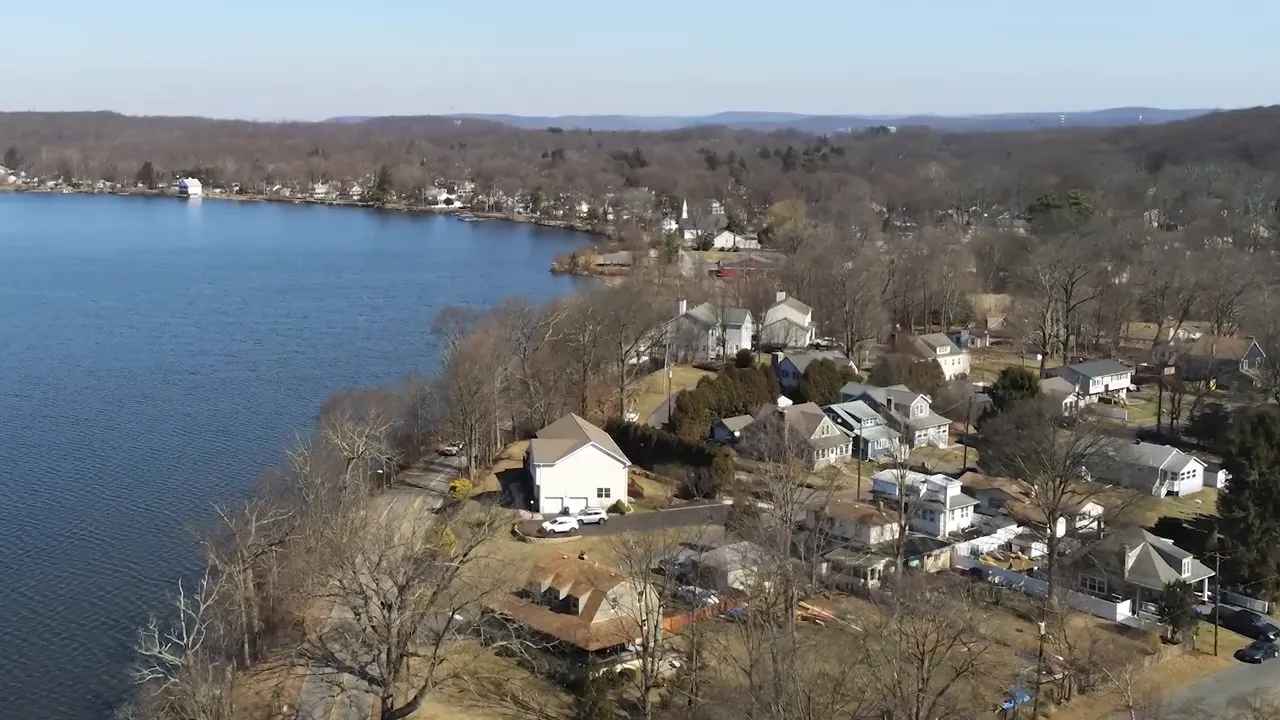 Aerial view of homes along Budd Lake with water and surrounding neighborhoods in Mount Olive Township, New Jersey
