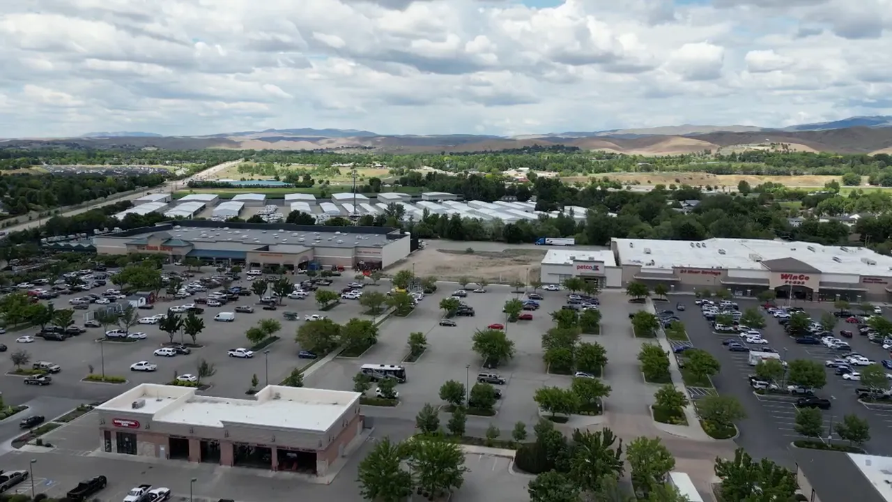 Modern shopping center with large storefronts and parking lot