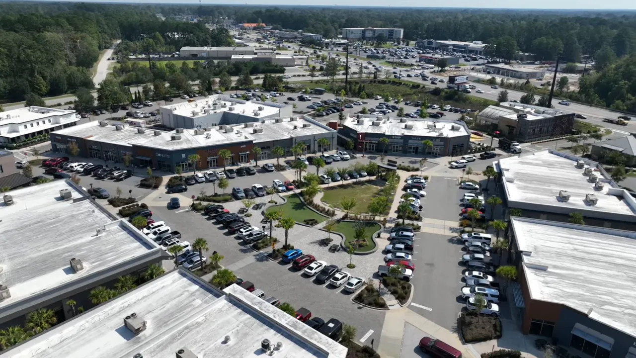Aerial drone photo of a Summerville shopping center and surrounding parking lots and roads.