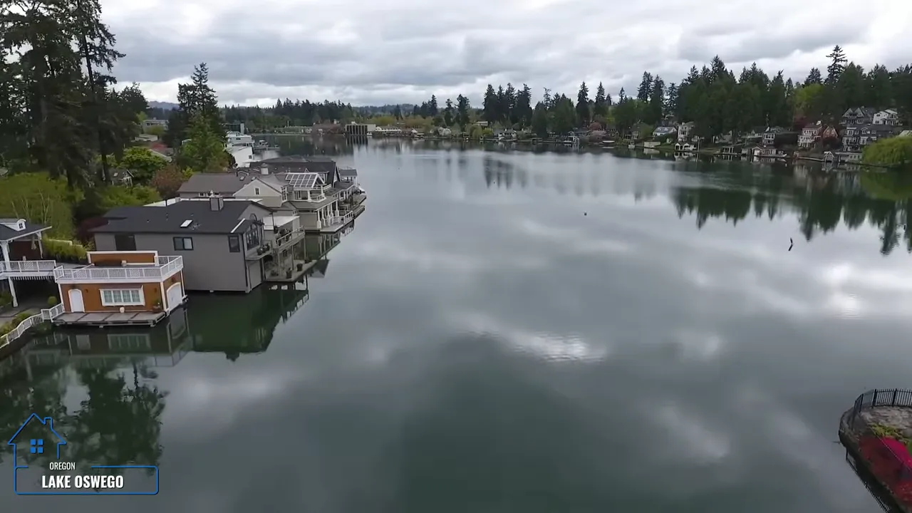 Wide view of calm lake water with docks and shoreline homes
