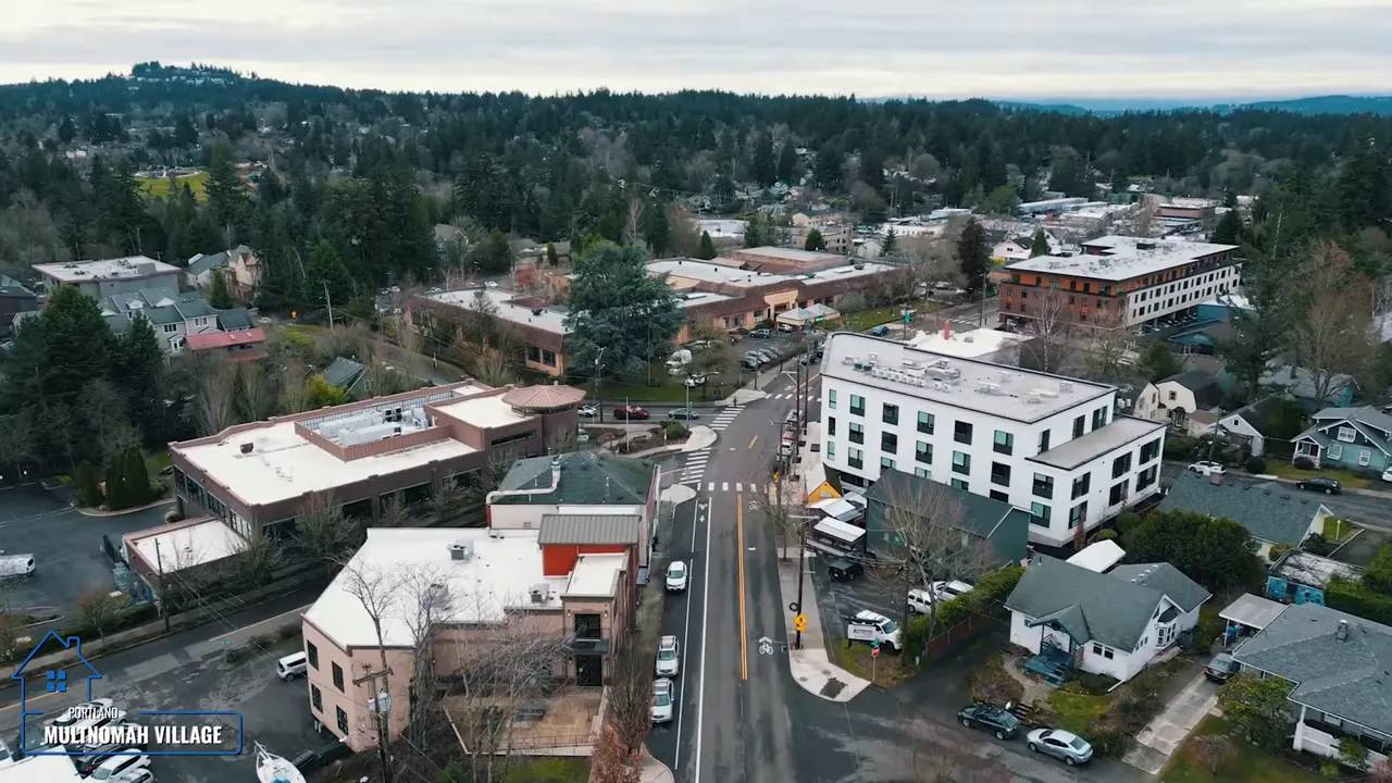 Aerial view of the Multnomah Village commercial area with streets and low-rise buildings