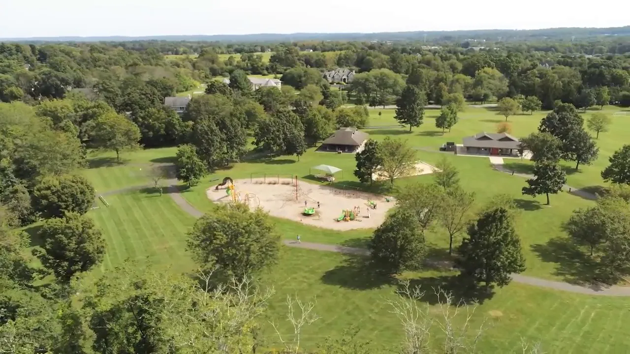 Aerial view of Bernards Township park grounds with walking paths, fields, and playground