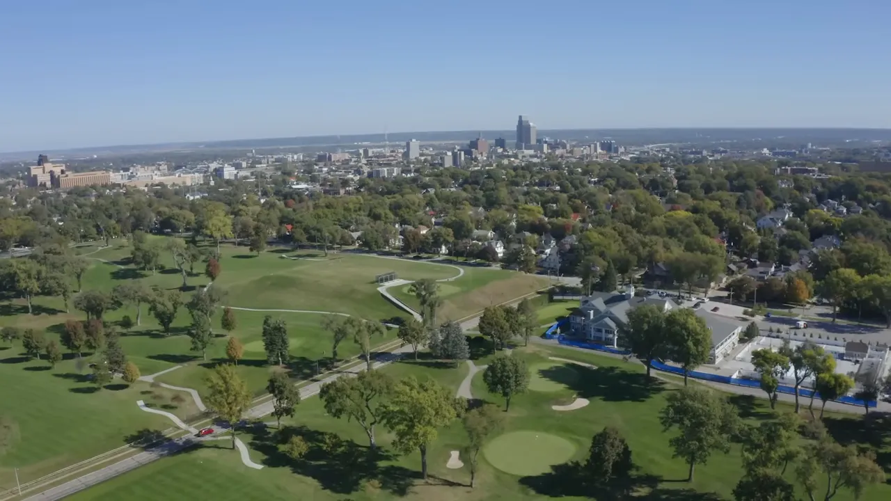 Aerial view of Omaha skyline with parkland and residential neighborhoods in the foreground
