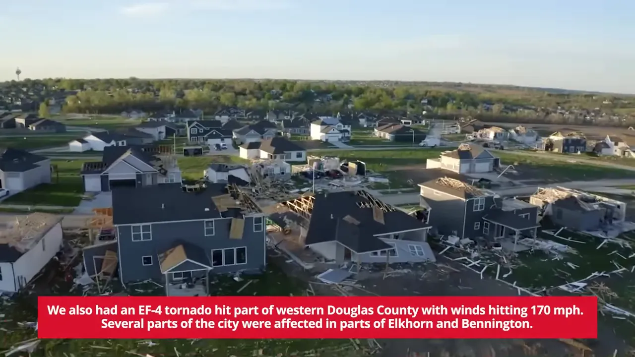 Aerial view of a suburban neighborhood with multiple homes severely damaged by an EF-4 tornado and debris scattered across yards.