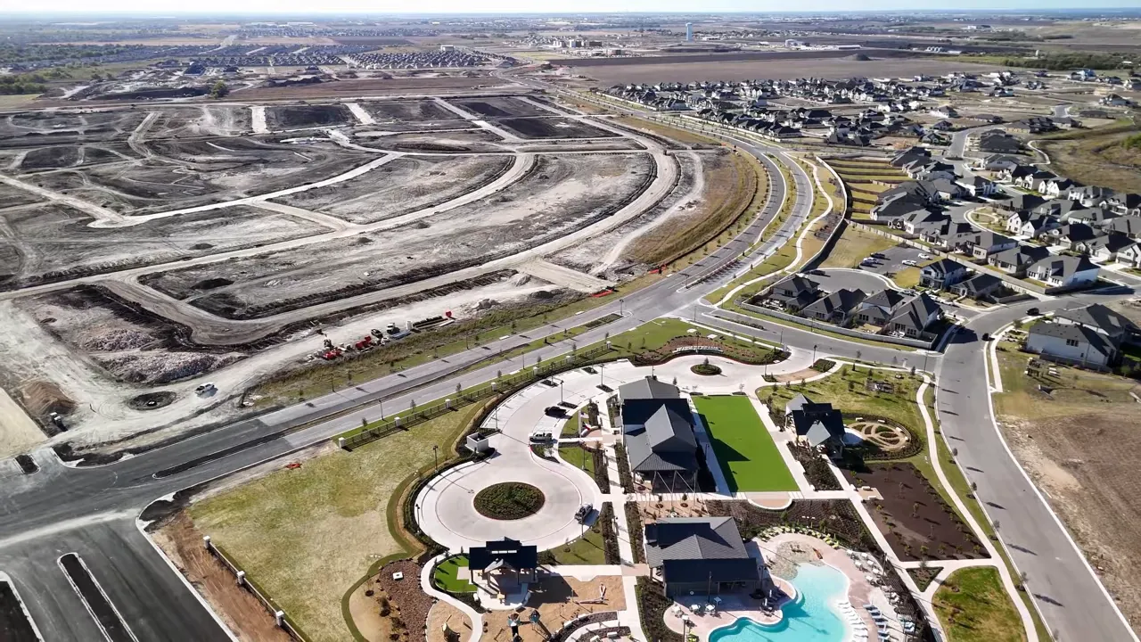Aerial view of a modern Austin-area neighborhood connected to wide highways and looping roads