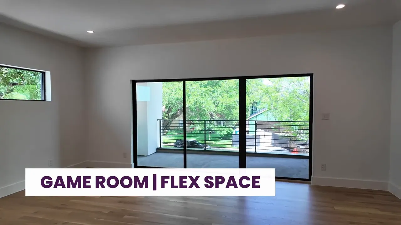 Upstairs game room flex space with triple sliding glass doors and labeled signage