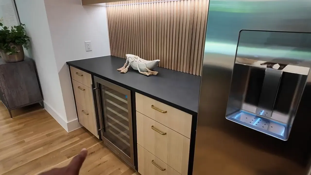 Kitchen side pantry pass-through with built-in drawers and stainless serving area