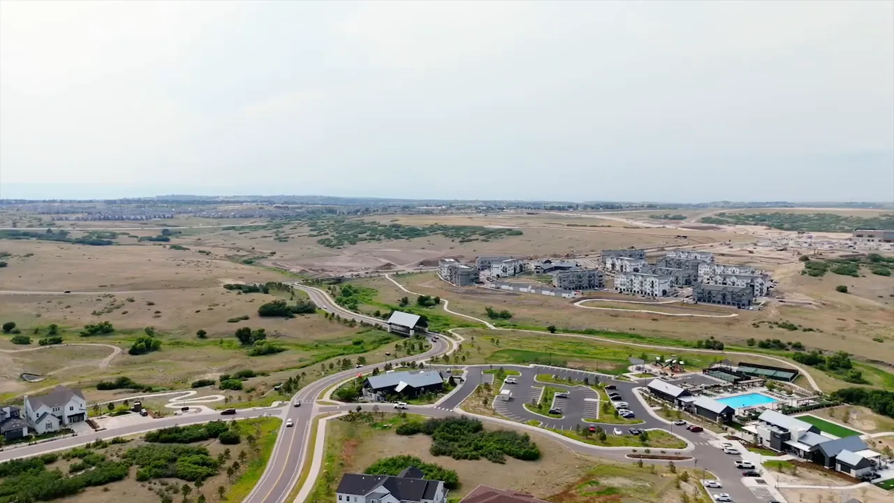 Aerial view of new homes and open land in a developing community