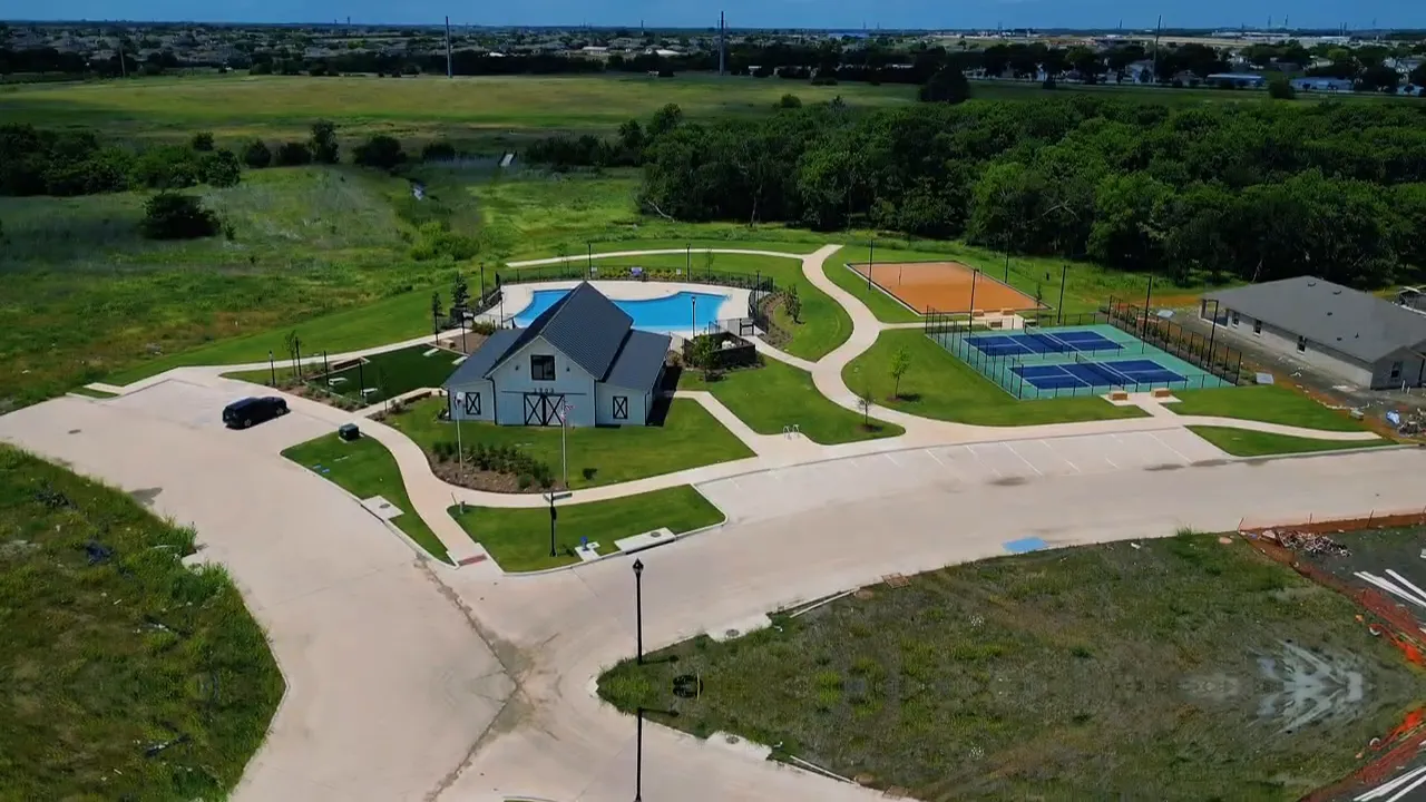 High-clear aerial view of community swimming pool and outdoor sports courts