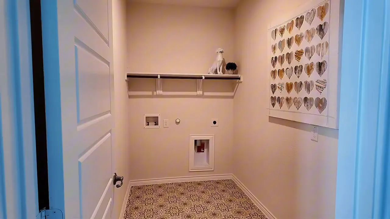 Wide view of first-floor flex room with built-in shelf, patterned carpet, and decorative wall hearts