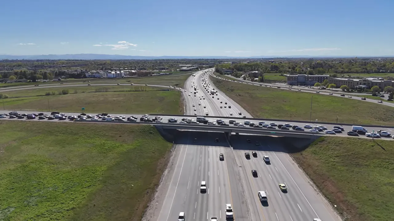 Aerial view of busy traffic crossing an interstate overpass