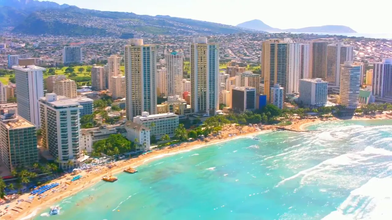 Aerial view of Waikiki beachfront with high-rise buildings and turquoise ocean