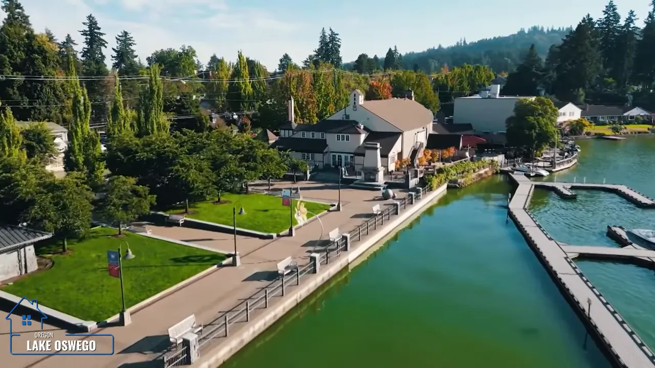 Lake Oswego waterfront promenade with homes docks and green lake water