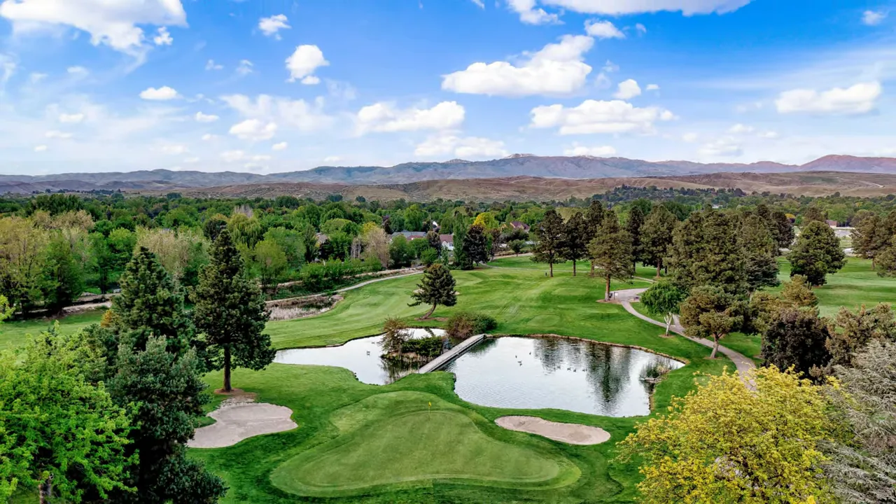 Golf course aerial view in Eagle, Idaho with water hazards and trees