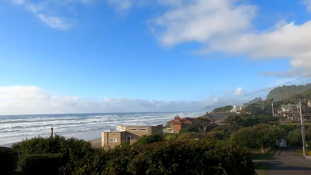 Ocean coastline and Arch Cape neighborhood seen from an elevated street
