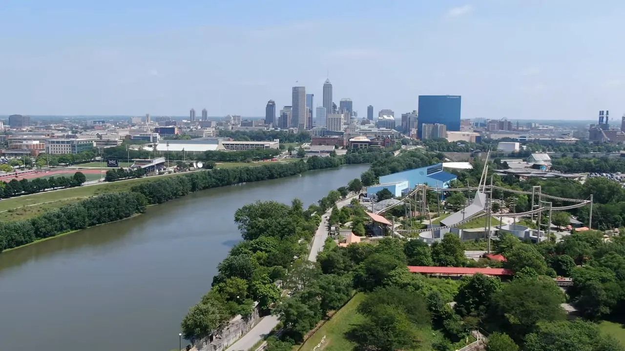 Aerial view of White River and Indianapolis skyline with park attractions