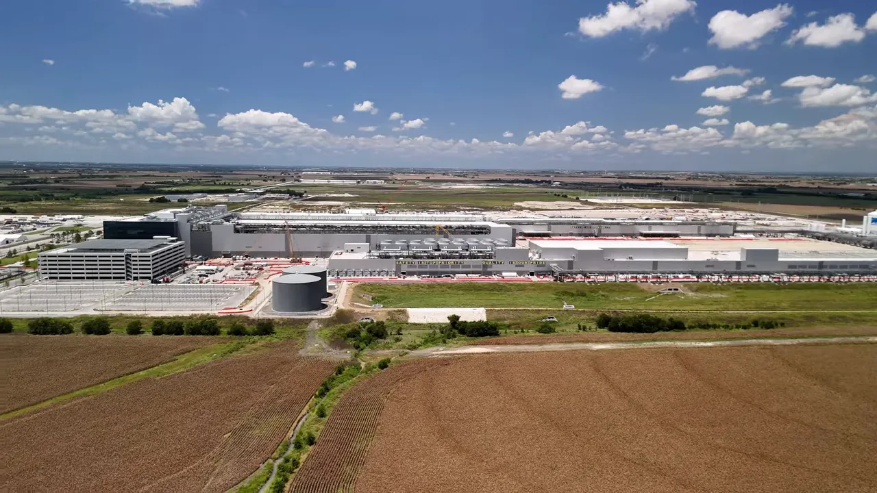 Aerial photo of a large industrial campus and adjacent fields under a blue sky