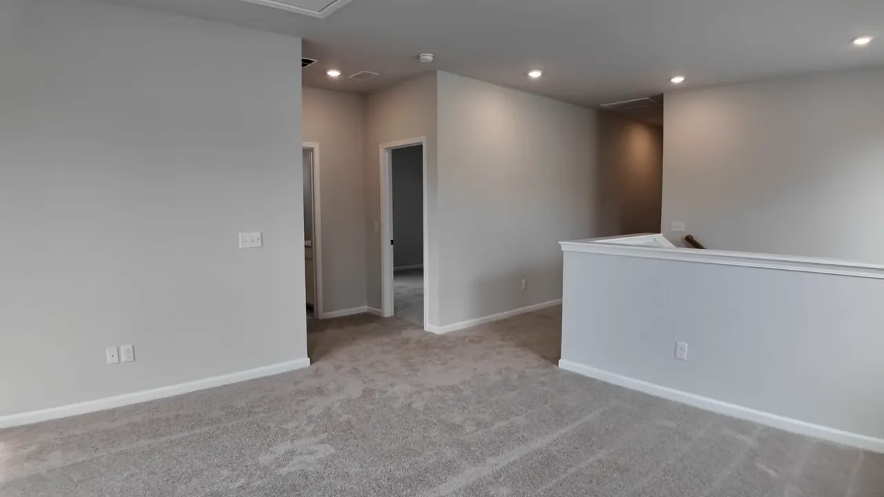 Upstairs room with new carpet, recessed lights, and open layout in a new construction home in Summers Corner SC