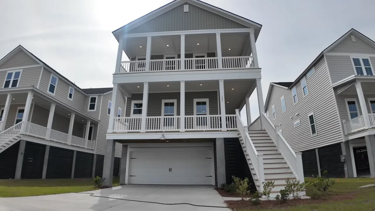Elevated new construction home exterior with double front porch and garage in Summers Corner, South Carolina