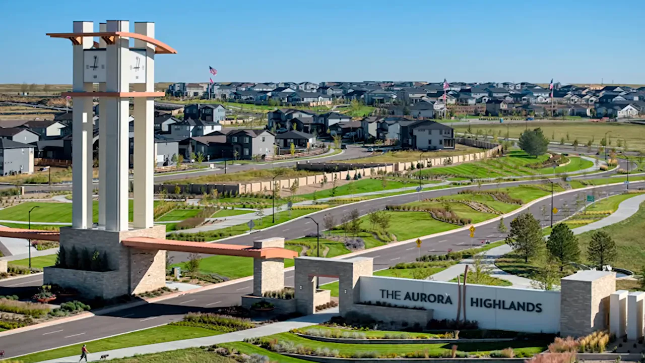 View of Aurora Highlands entrance sign and landscaped neighborhood streets in northeast Aurora Colorado