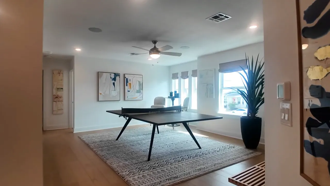 Upstairs game room with ping pong table and large windows