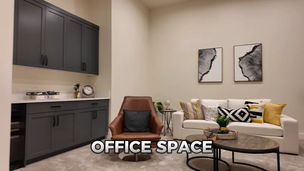 Staged office space with sofa chairs coffee tables and dark built in cabinets