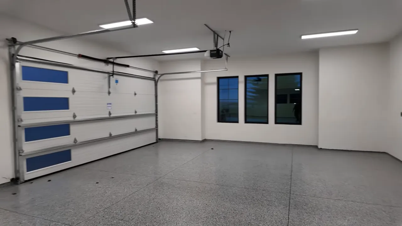 Large finished RV garage with multiple garage doors and epoxy floor
