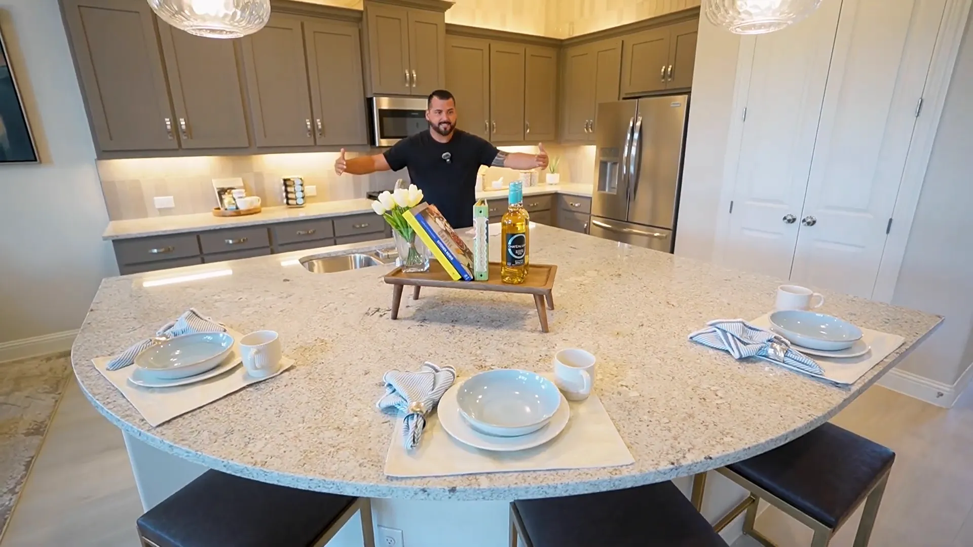 Grand kitchen with large island and painted cabinets