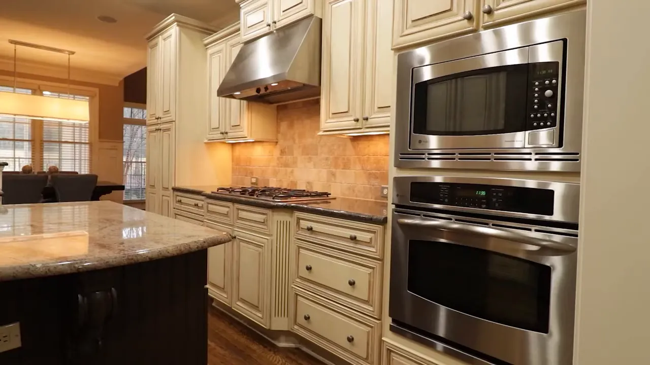 Bright kitchen with cream cabinets granite counters and stainless steel appliances