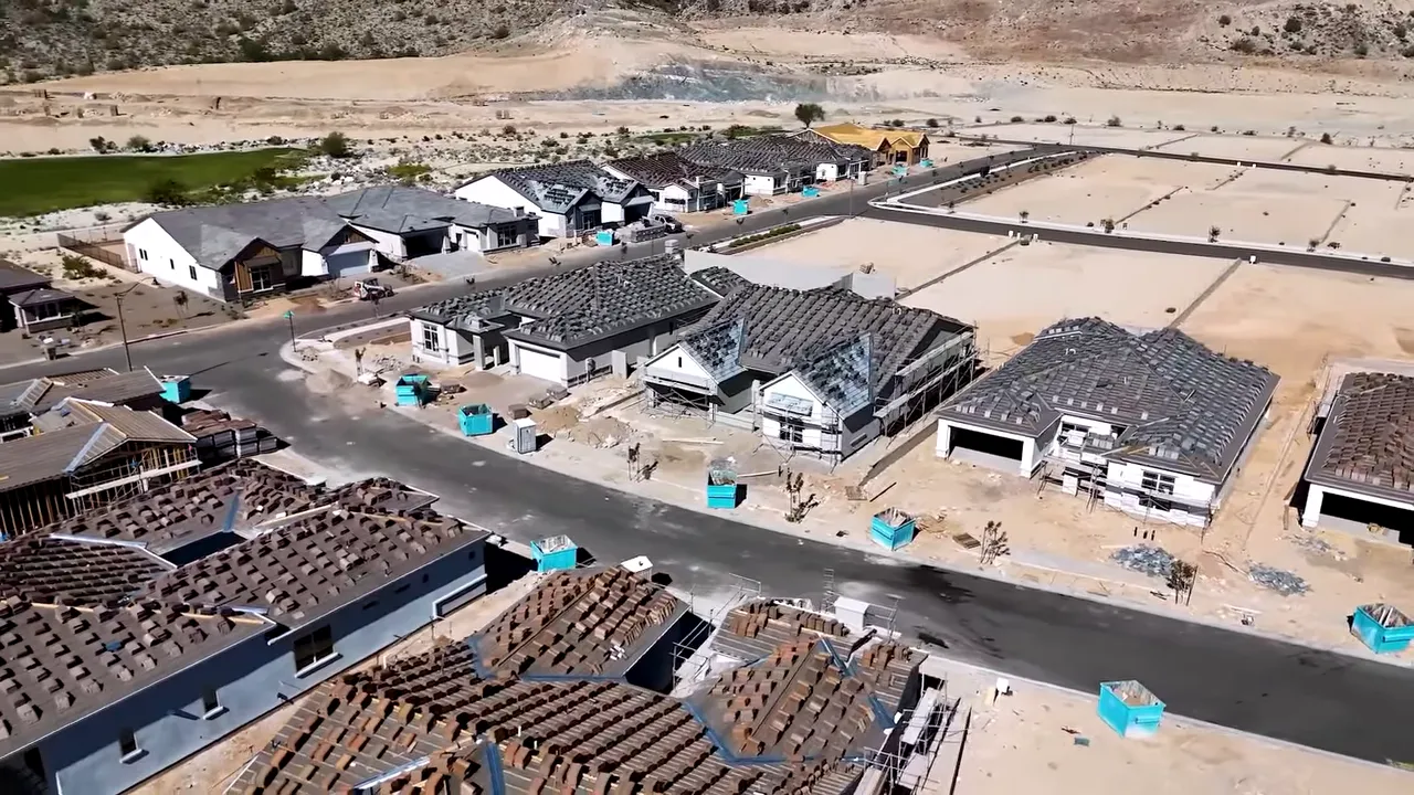 Aerial view of a housing development with multiple newly built homes and construction activity in Phoenix area