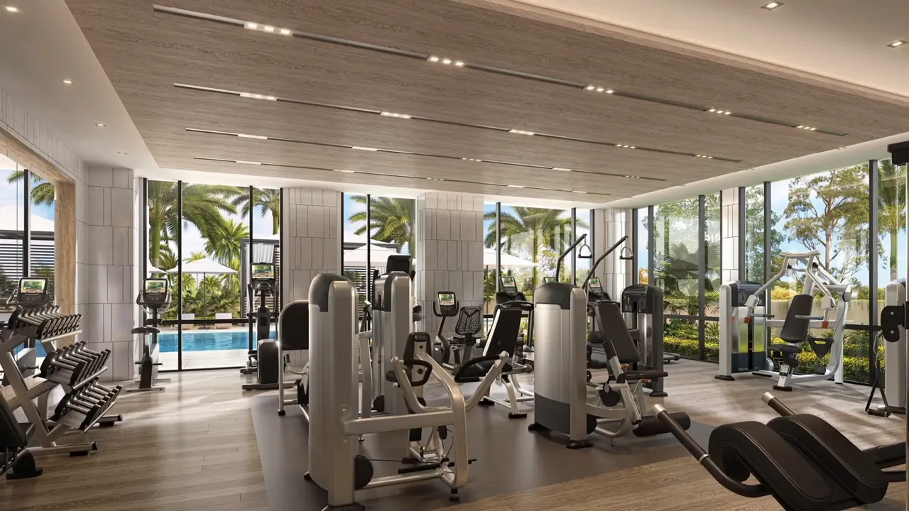 Modern fitness center with strength and cardio equipment near glass walls