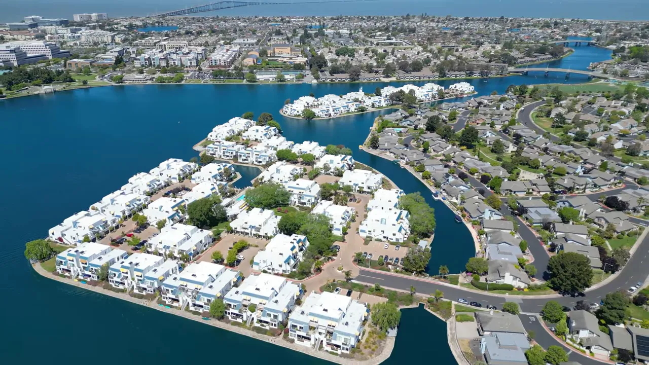 Aerial view of Foster City's lagoons, canals and waterfront homes with the Bay in the background