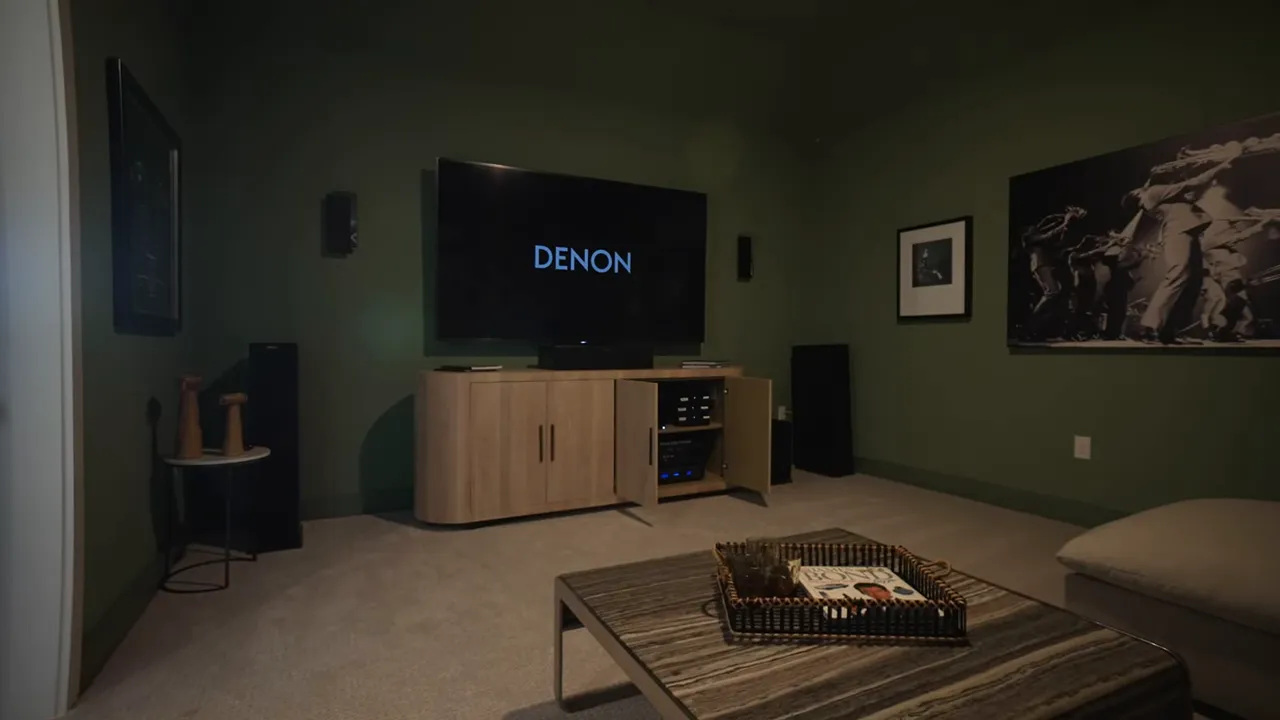 Dark media room with large television and lounge seating
