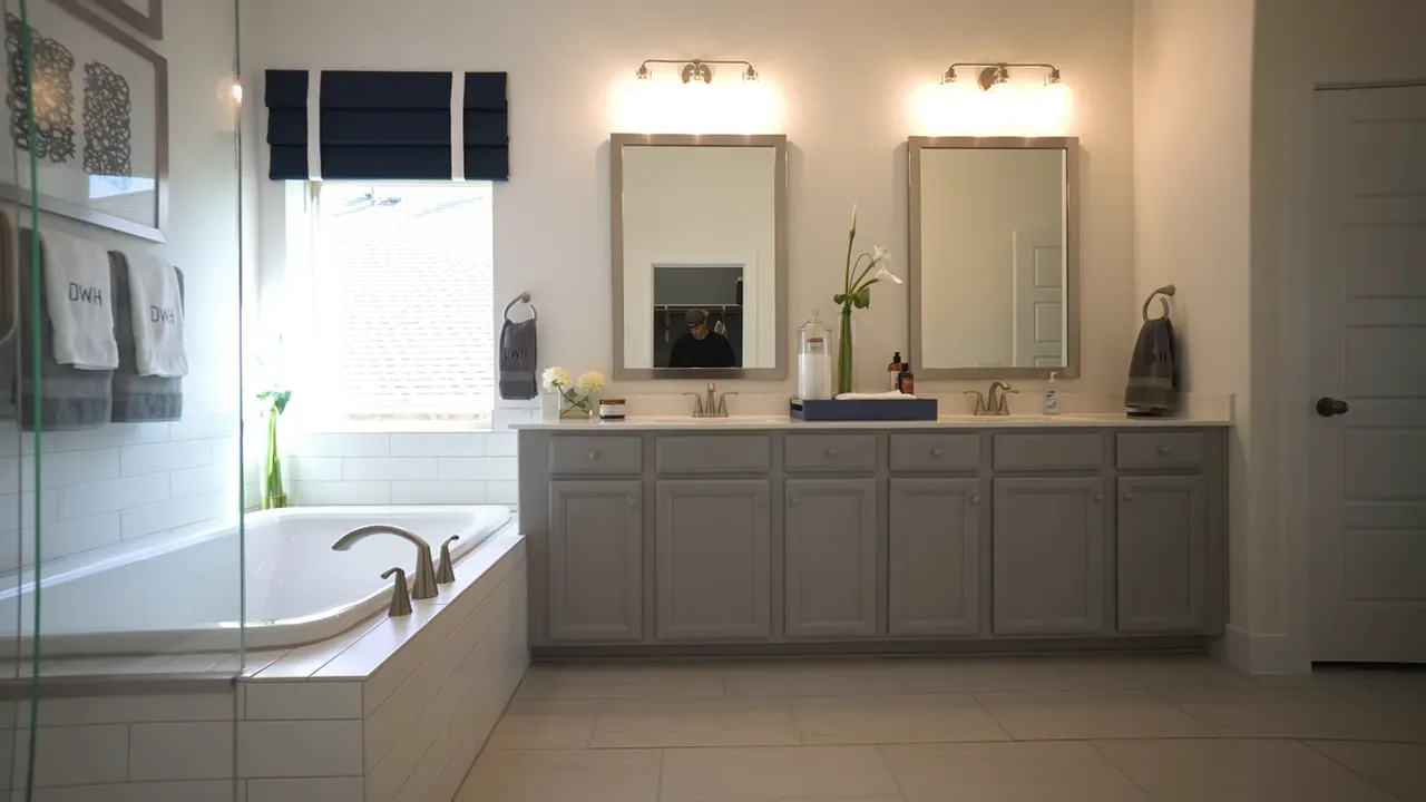 Primary bathroom with double vanity mirrors soaking tub and bright windows