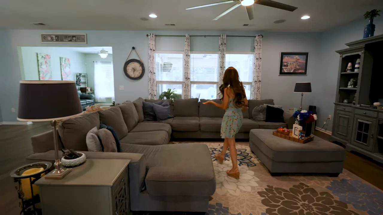 Open living room with large sectional windows and built in style wall unit