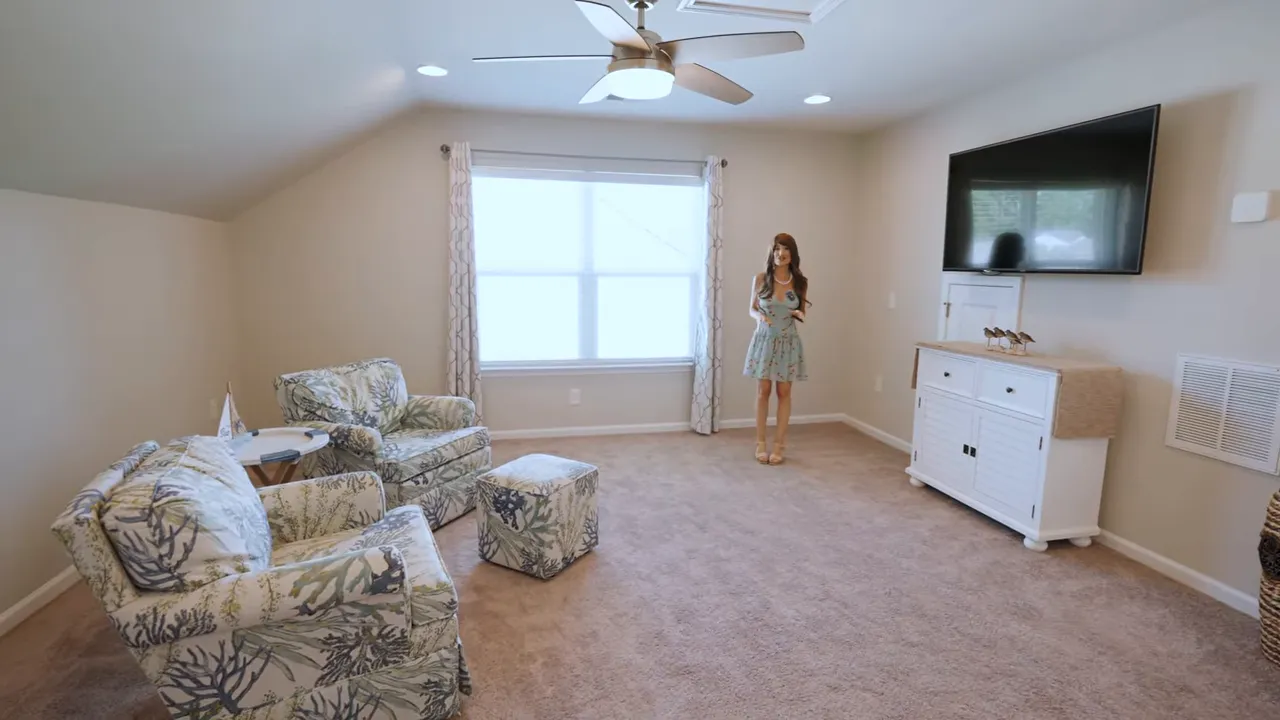 Upstairs loft area with chairs dresser wall mounted television and window